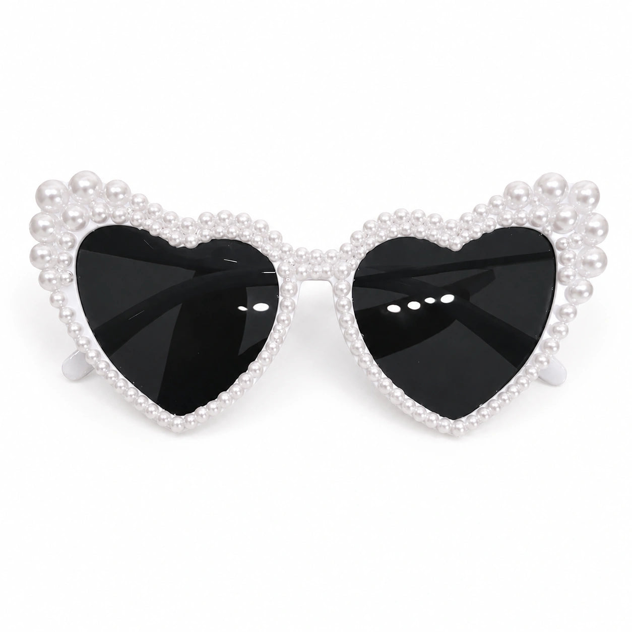 Heart-shaped sunglasses with black lenses and pearl-like embellishments on a white background