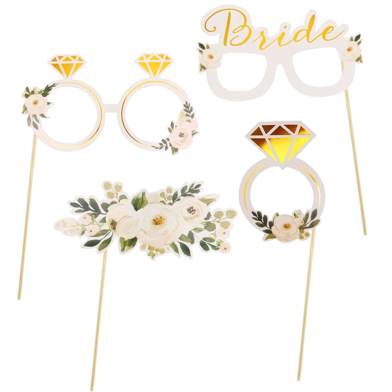 Decorative glasses with floral and gemstone designs on sticks against a white background