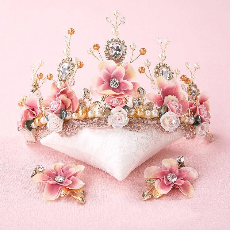 Floral tiara with pink flowers and decorative elements on a pink background