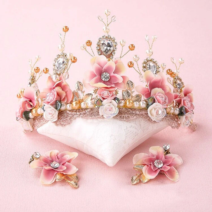 Floral tiara with pink flowers and decorative elements on a pink background