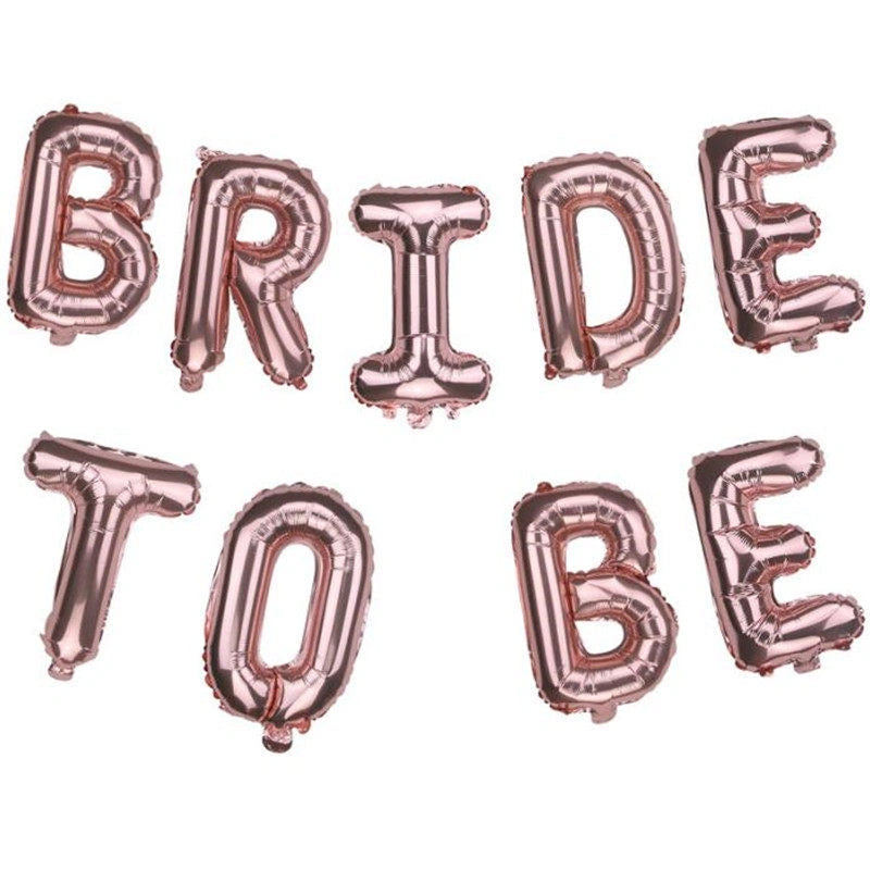 Rose gold foil balloon letters spelling out 'BRIDE TO BE' arranged in two rows on a plain white background.