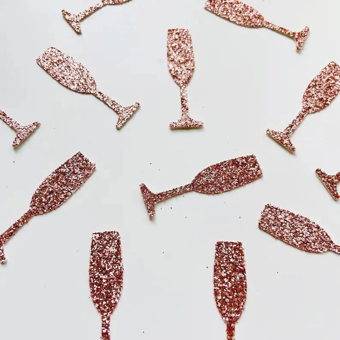 Rose gold glittery champagne glass shapes on a white background