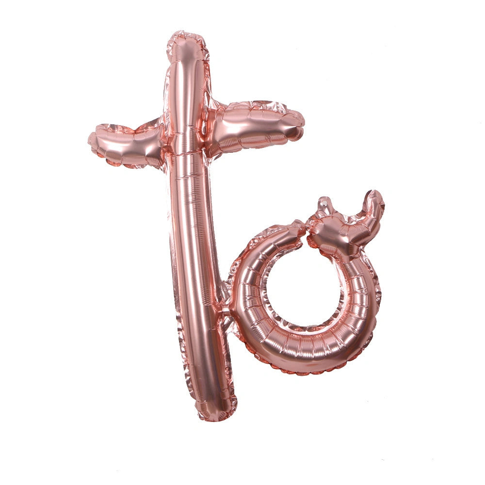 Rose gold balloon letters 'to' on a white background