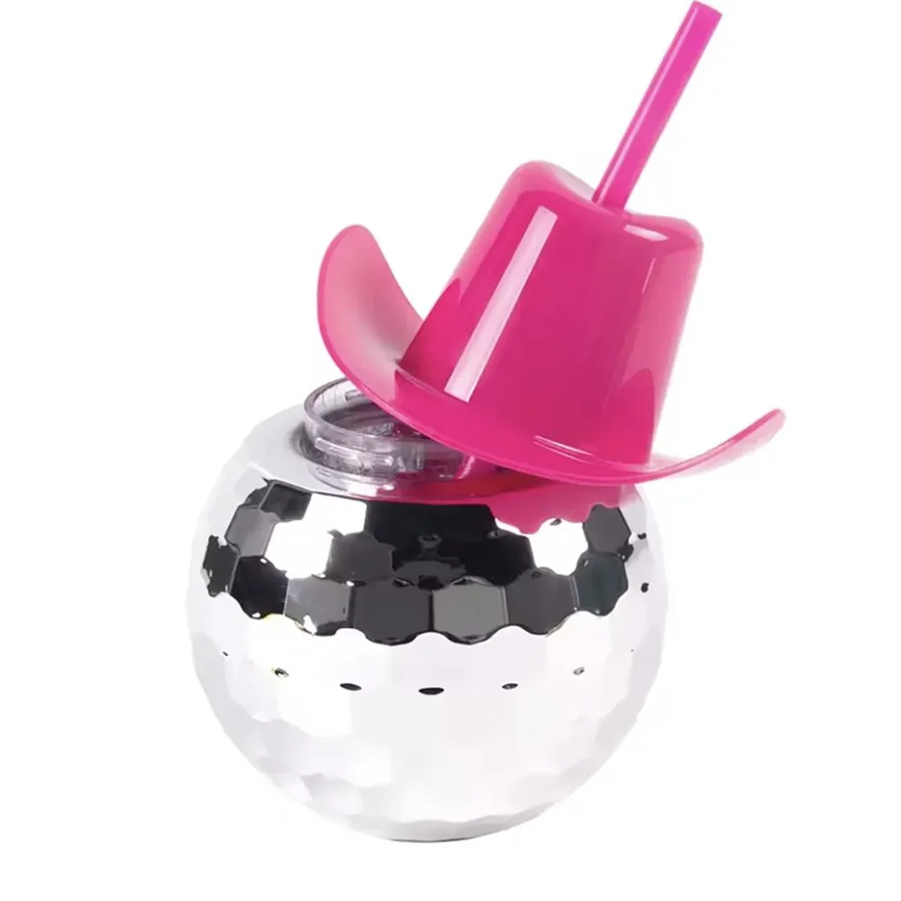 Silver disco ball with a pink straw lid on a white background
