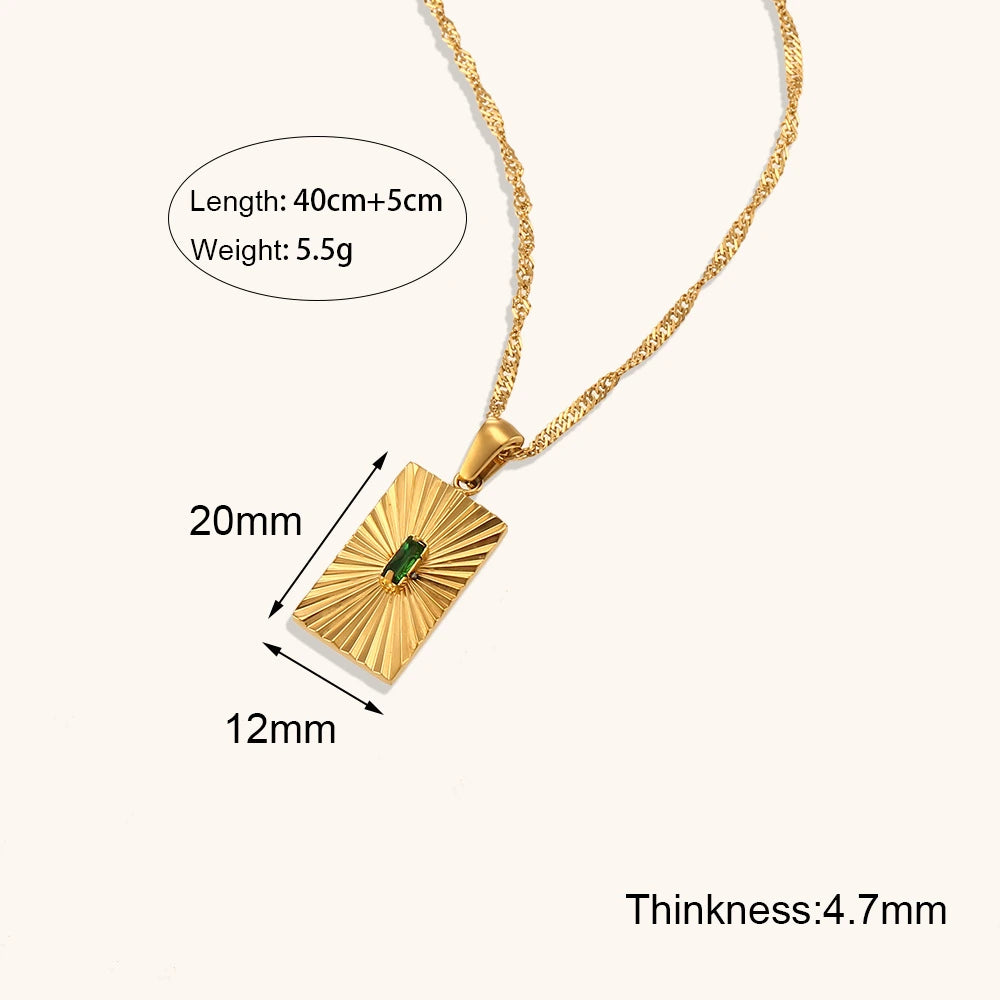 Gold necklace with pendant showing measurements on a white background