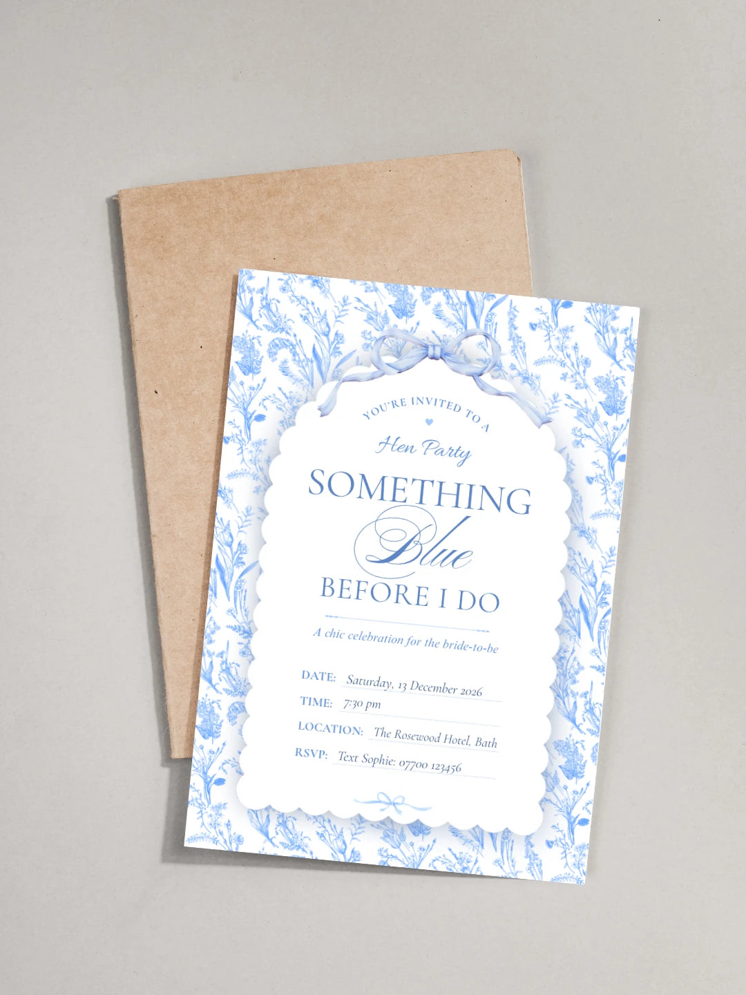 Hen party invitation card with blue floral design and brown envelope on a gray background