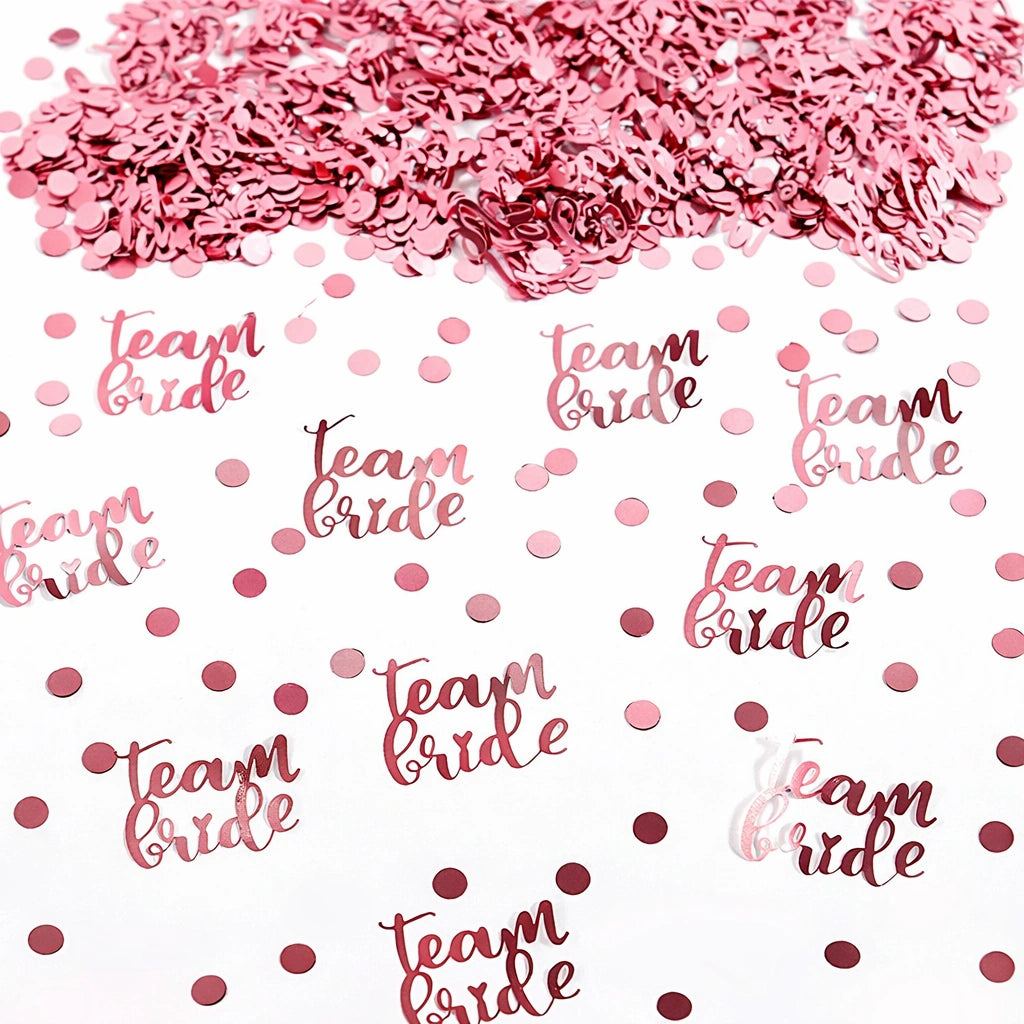Pink 'team bride' confetti on a white background