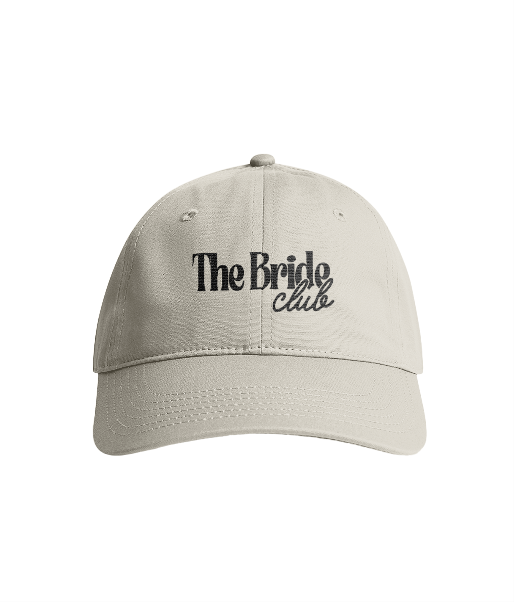 White cap with 'The Bride Club' in black embroidered text.