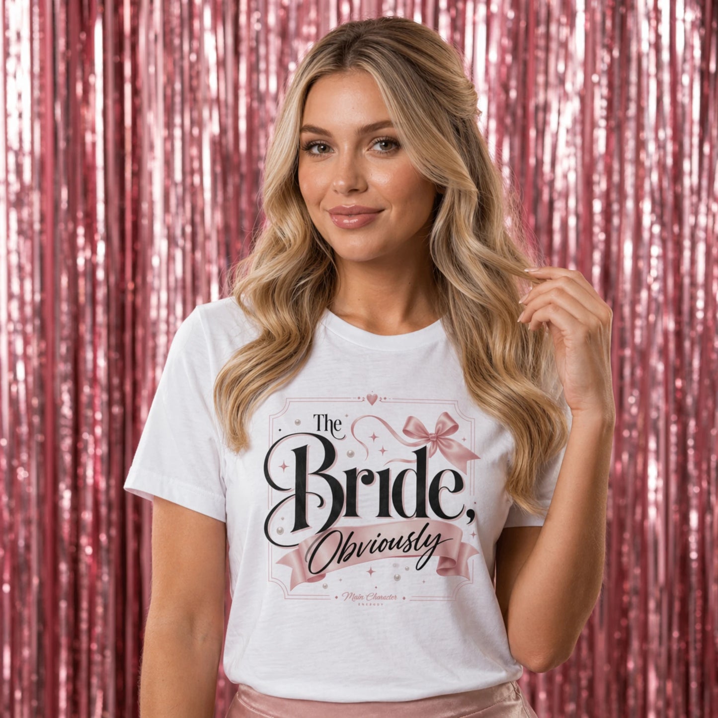 Woman wearing a white t-shirt with 'The Bride, Obviously' text against a pink sequin curtain background