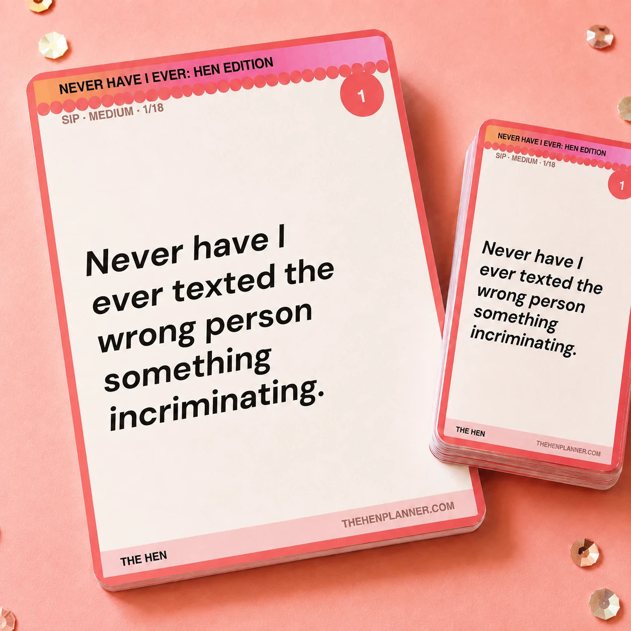 A pink and white card deck and single card from The Hen Planner, featuring humorous text quotes, arranged on a peach-pink background.