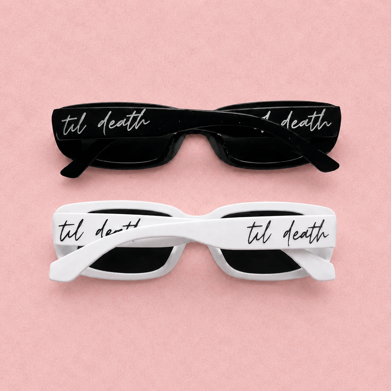 Black and white sunglasses with 'til death' text on a pink background