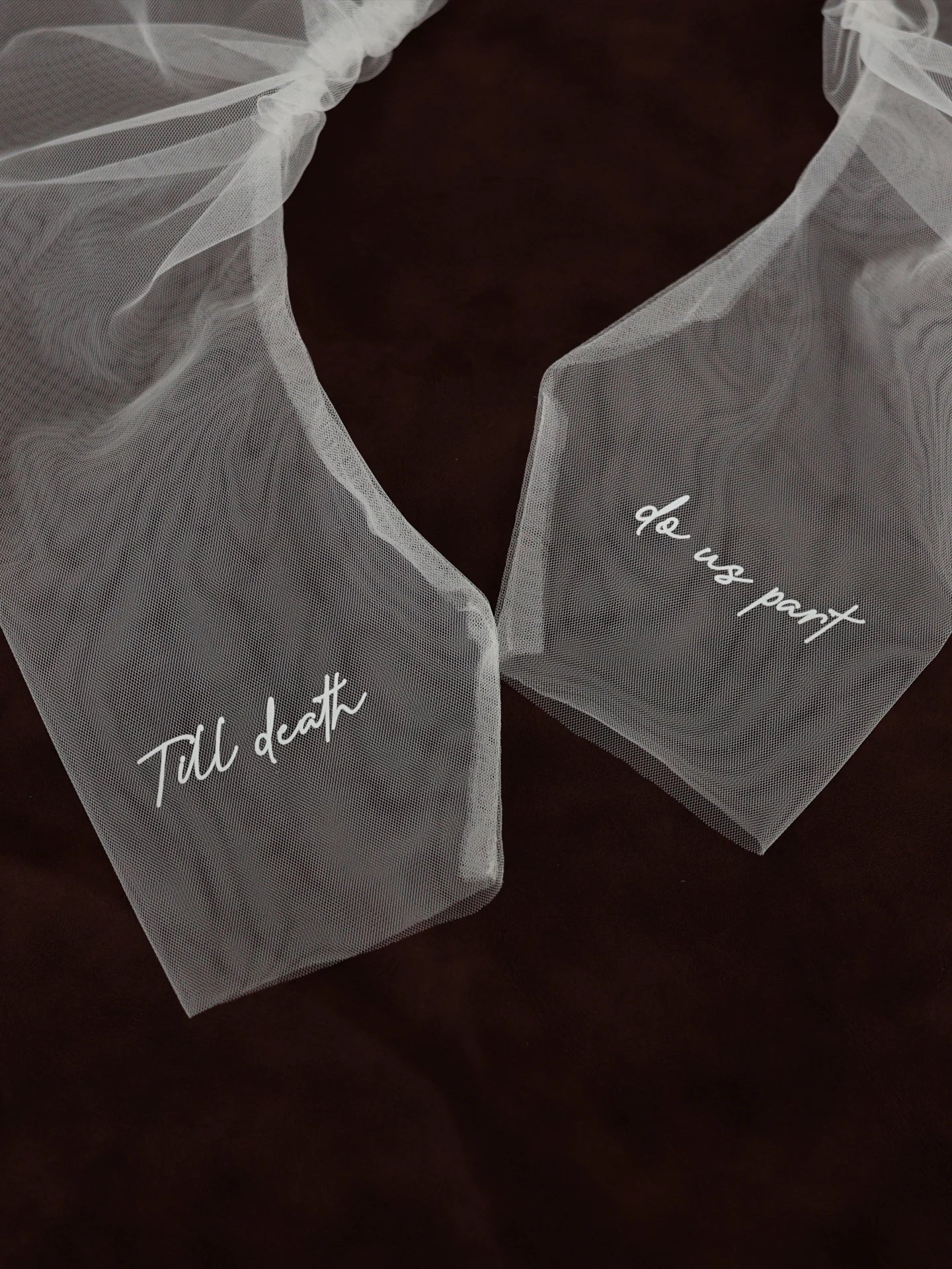 Two white wedding garter sets with text on a dark background