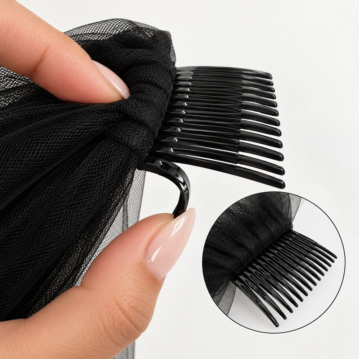 A close-up of a black veil with a black hair comb.