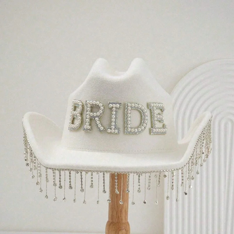 White cowboy hat with 'BRIDE' embellishments on a white background