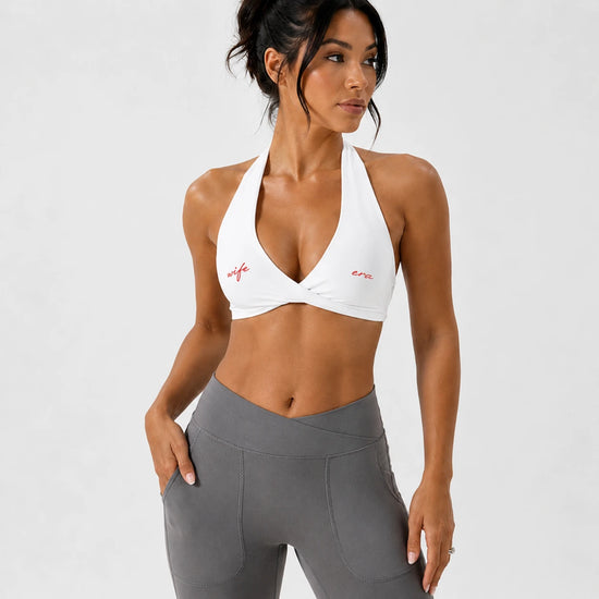 Bride wearing a white Wife Era halter sports bra from Vow Club