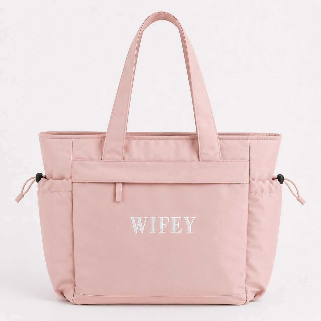 Pink tote bag with 'WIFEY' text on a light gray background