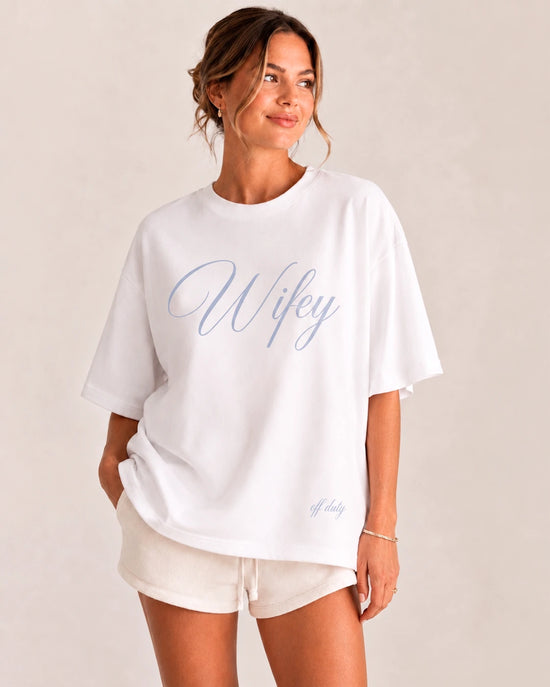 Woman wearing a white Wifey Off Duty oversized bridal T-shirt