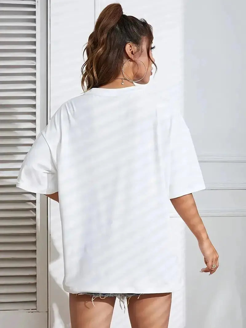 Woman wearing a loose-fitting white t-shirt against a light background