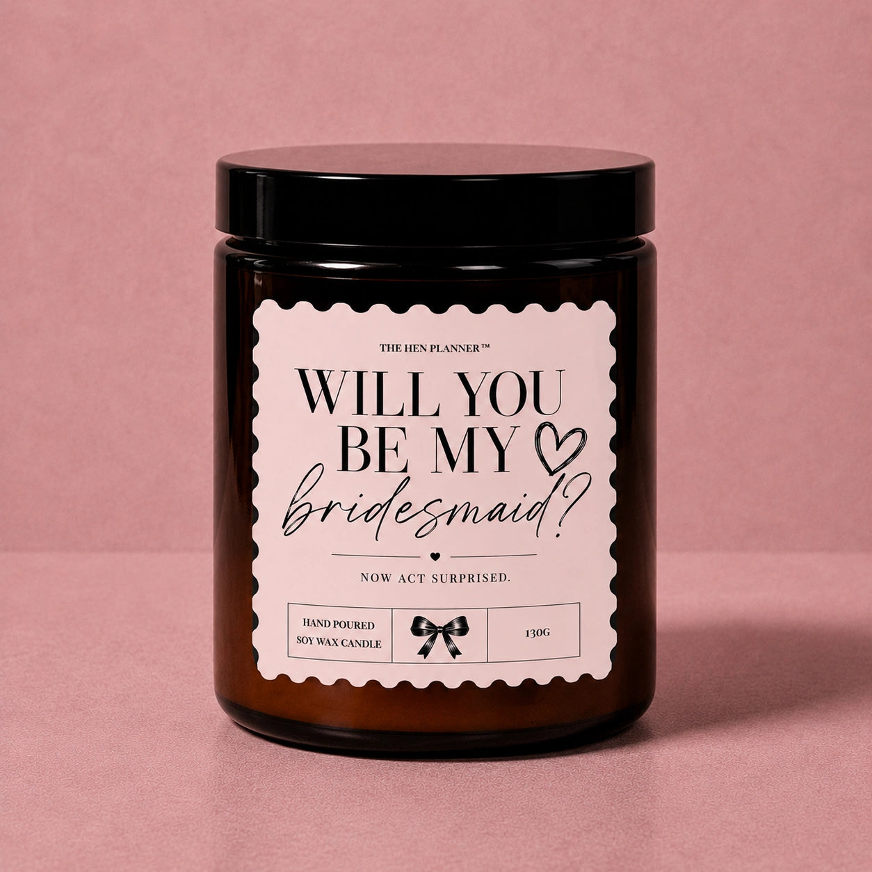 Candle with 'Will You Be My Bridesmaid?' label on a pink background