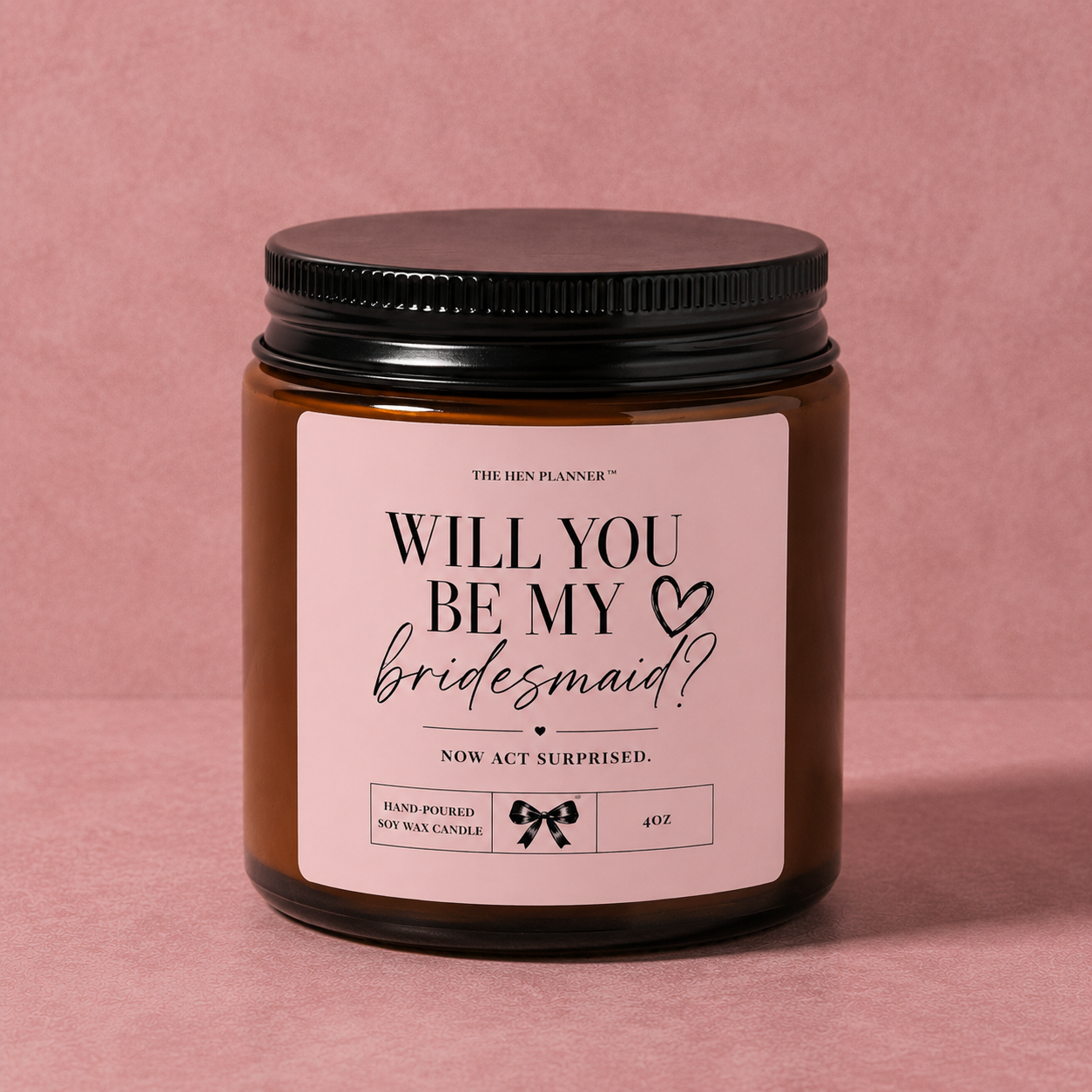 'Will You Be My Bridesmaid' candle jar with 'Will You Be My Bridesmaid?' label on a pink background